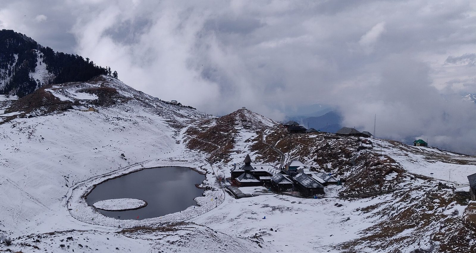 Prashar Lake ringed by fresh snow in the Himachal winter